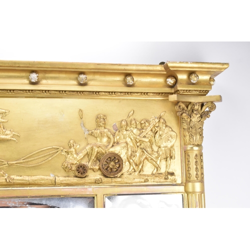 264 - A late 19th/early 20th century gilt overmantle triple-plate mirror, the frieze decorated with a depi... 