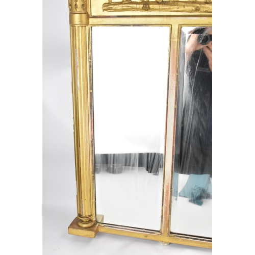 264 - A late 19th/early 20th century gilt overmantle triple-plate mirror, the frieze decorated with a depi... 