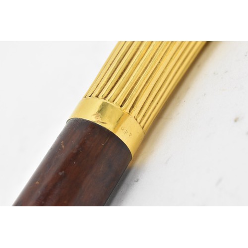 243 - An early 20th century gold plated handled walking stick, the handle of reeded form and stamped G.O.P... 