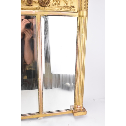 264 - A late 19th/early 20th century gilt overmantle triple-plate mirror, the frieze decorated with a depi... 