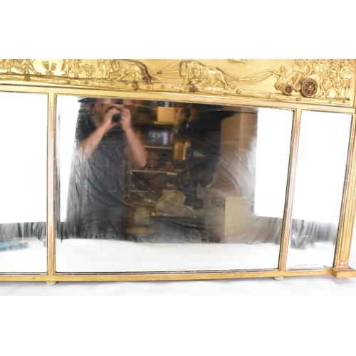 264 - A late 19th/early 20th century gilt overmantle triple-plate mirror, the frieze decorated with a depi... 