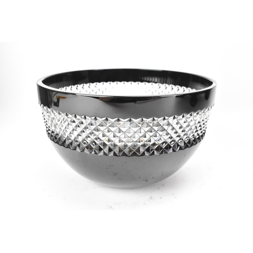 28 - A Waterford black lead crystal cut bowl, designed by John Rocha, with a clear diamond cut rim, etche... 