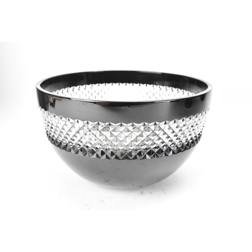 28 - A Waterford black lead crystal cut bowl, designed by John Rocha, with a clear diamond cut rim, etche... 