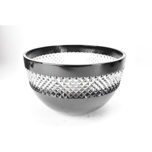 28 - A Waterford black lead crystal cut bowl, designed by John Rocha, with a clear diamond cut rim, etche... 