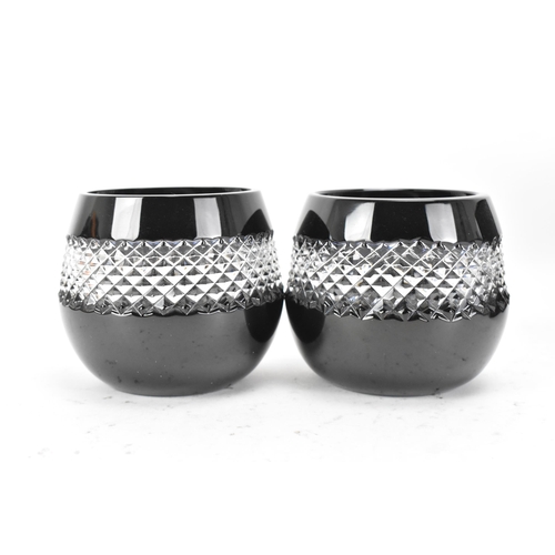 31 - A pair of Waterford black lead crystal cut votive glasses, designed by John Rocha, each having a cle... 