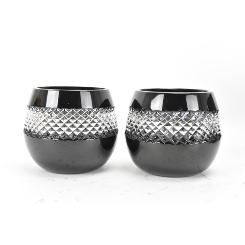 31 - A pair of Waterford black lead crystal cut votive glasses, designed by John Rocha, each having a cle... 