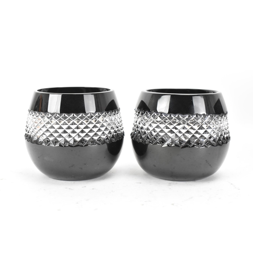 31 - A pair of Waterford black lead crystal cut votive glasses, designed by John Rocha, each having a cle... 