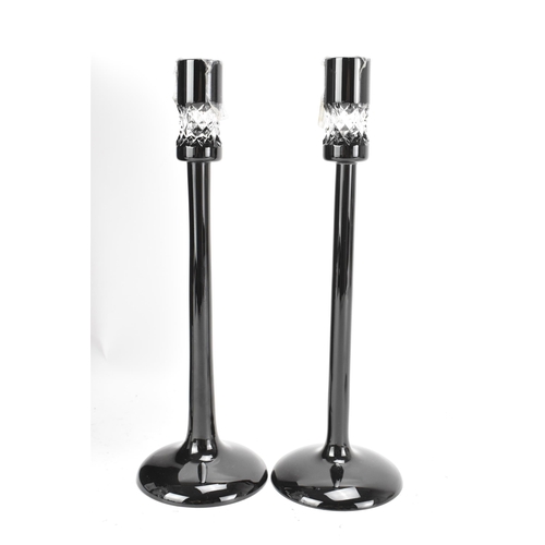 32 - A pair of Waterford black lead crystal cut candlesticks, designed by John Rocha, each of tapered for... 