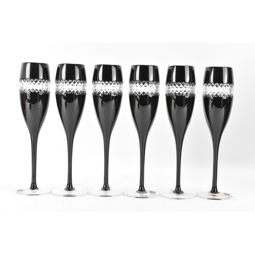 33 - A set of six Waterford black lead crystal cut champagne flutes, designed by John Rocha, each of tape... 