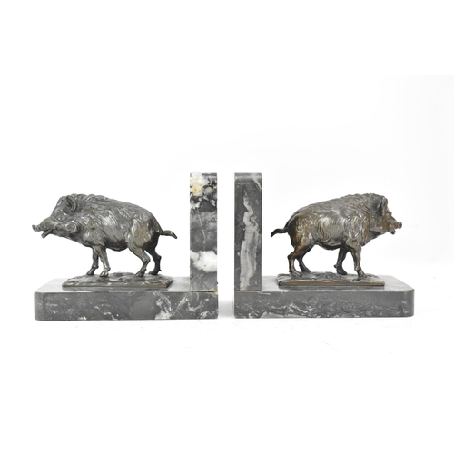 46 - A pair of Art Deco cast spelter bookends in the form of boars standing on naturalistic bases and eac... 