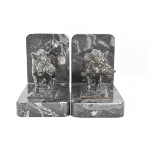 46 - A pair of Art Deco cast spelter bookends in the form of boars standing on naturalistic bases and eac... 