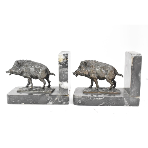 46 - A pair of Art Deco cast spelter bookends in the form of boars standing on naturalistic bases and eac... 