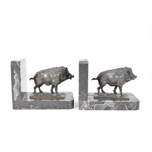 46 - A pair of Art Deco cast spelter bookends in the form of boars standing on naturalistic bases and eac... 