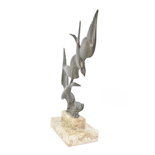 8 - An Art Deco bronze effect sculpture of two birds in flight, mounted on a stepped marble base, signed... 