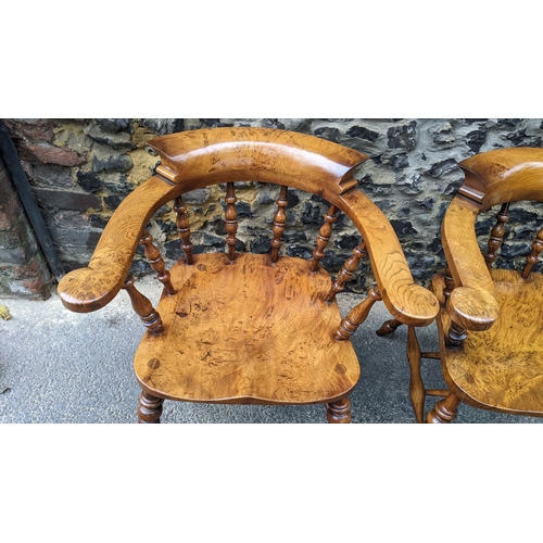 88 - A pair of Stewart Linford elm and ash captains armchairs, each having a curved top rail, spade arm s... 