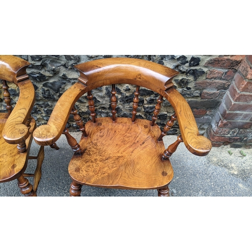 88 - A pair of Stewart Linford elm and ash captains armchairs, each having a curved top rail, spade arm s... 