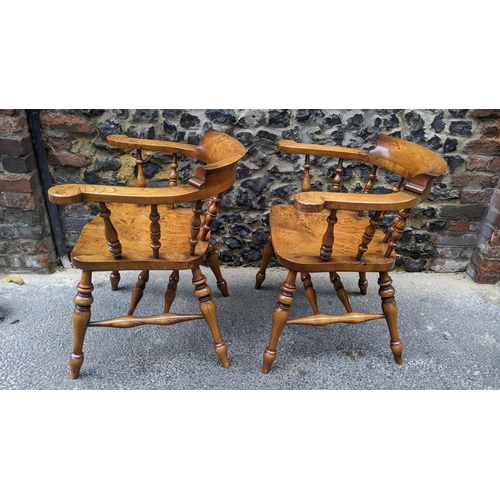 88 - A pair of Stewart Linford elm and ash captains armchairs, each having a curved top rail, spade arm s... 