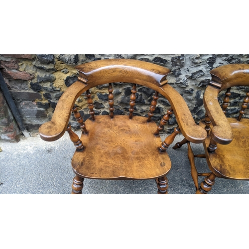 89 - A pair of Stewart Linford elm and ash captains armchairs, each having a curved top rail, spade arm s... 