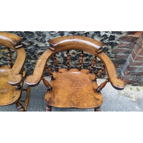 89 - A pair of Stewart Linford elm and ash captains armchairs, each having a curved top rail, spade arm s... 