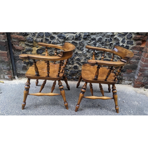 89 - A pair of Stewart Linford elm and ash captains armchairs, each having a curved top rail, spade arm s... 