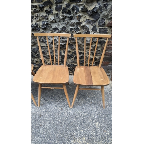 90 - A set four 1960s Ercol elm and beech model 391 'kitchen chairs', stick back over shaped seat, taperi... 