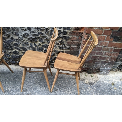 90 - A set four 1960s Ercol elm and beech model 391 'kitchen chairs', stick back over shaped seat, taperi... 