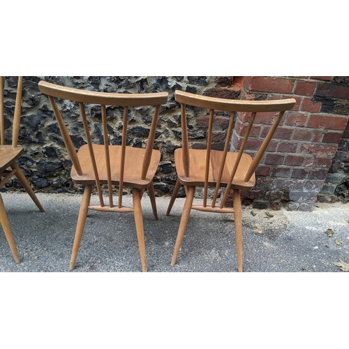 90 - A set four 1960s Ercol elm and beech model 391 'kitchen chairs', stick back over shaped seat, taperi... 