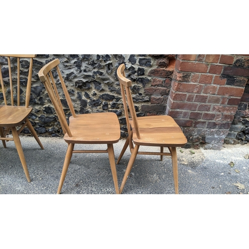 90 - A set four 1960s Ercol elm and beech model 391 'kitchen chairs', stick back over shaped seat, taperi... 