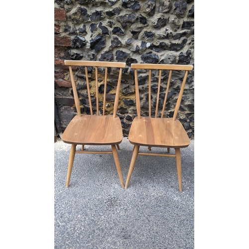 90 - A set four 1960s Ercol elm and beech model 391 'kitchen chairs', stick back over shaped seat, taperi... 