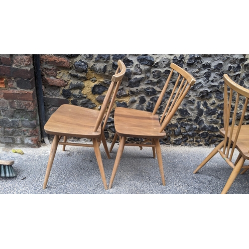 90 - A set four 1960s Ercol elm and beech model 391 'kitchen chairs', stick back over shaped seat, taperi... 