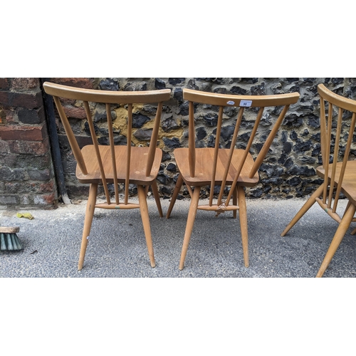 90 - A set four 1960s Ercol elm and beech model 391 'kitchen chairs', stick back over shaped seat, taperi... 