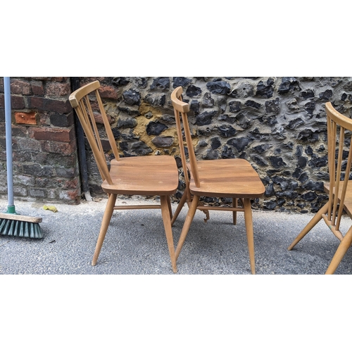 90 - A set four 1960s Ercol elm and beech model 391 'kitchen chairs', stick back over shaped seat, taperi... 