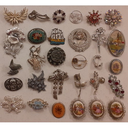 82 - A collection of brooches to include a white metal and enamelled Thai brooch of a ship, a micro-mosai... 