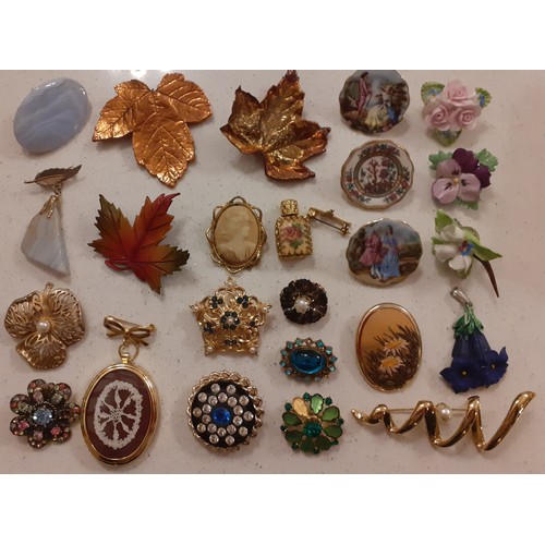 82 - A collection of brooches to include a white metal and enamelled Thai brooch of a ship, a micro-mosai... 