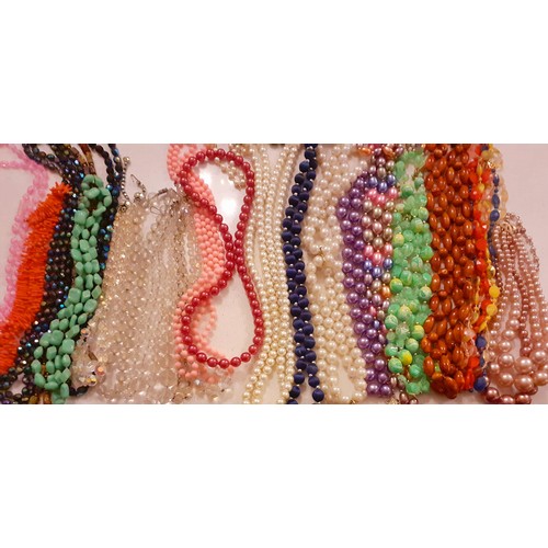 76 - A large quantity of vintage bead necklaces to include Aurora Borealis examples and simulated pearls ... 