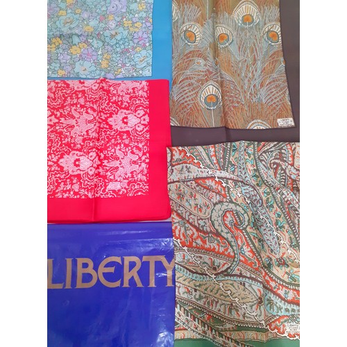 56 - Liberty-Four 1970's and early 1980's silk scarves to include a brown oversized scarf with peacock fe... 