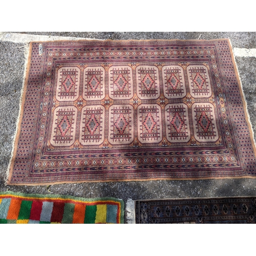 102 - Two Pakistan Bokhara rugs largest 188cms & 121cms and a geometric wool rug
Location: STAIRS
If there... 