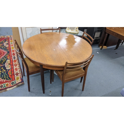 101 - A mid 20th century G plan teak extending dining table together with four chairs 74h x 122w unextende... 