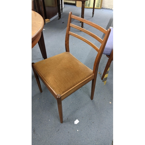 101 - A mid 20th century G plan teak extending dining table together with four chairs 74h x 122w unextende... 