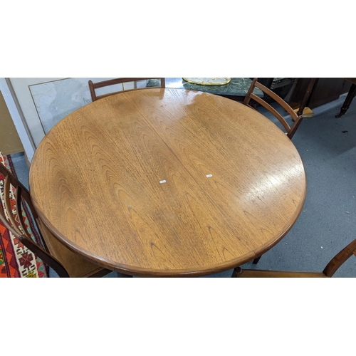 101 - A mid 20th century G plan teak extending dining table together with four chairs 74h x 122w unextende... 