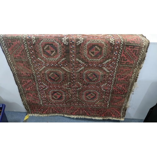 15 - A Persian hand woven red ground rug having geometric designs and tasselled ends, 224cm x 123cm w
Loc... 