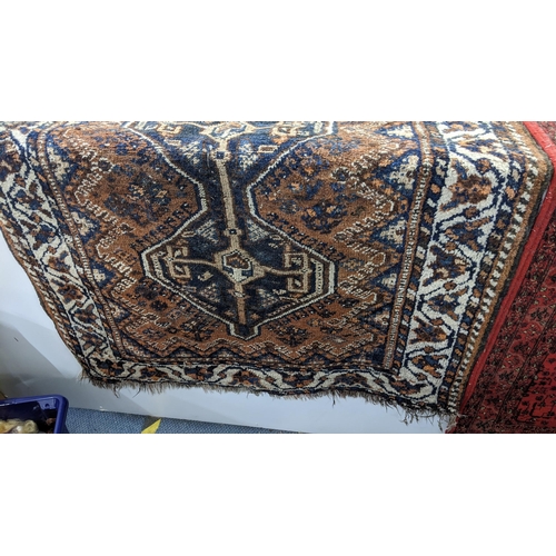 16 - Two rugs to include an Afghan brown and blue ground hand woven rug, 126cm x 112cm, and a machine wov... 