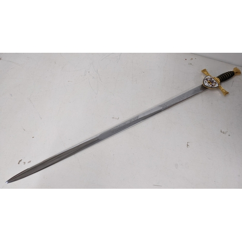 19 - A Wilkinson modern sword, having a leather grip with wire banding, gilt cross guard and with an enam... 