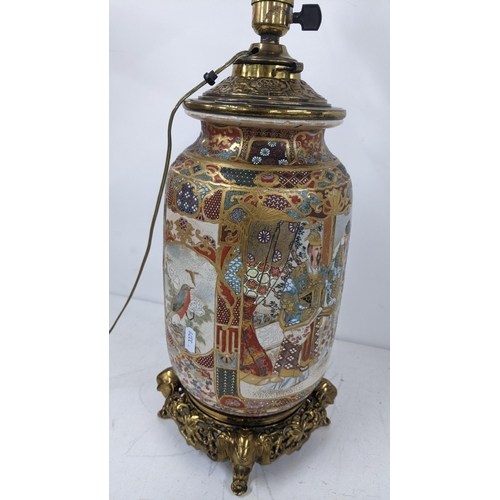 5 - A Japanese Meiji Satsuma table lamp decorated with panels of birds and figures, gilt mounts with ele... 