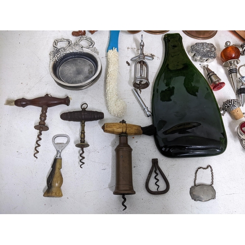 41 - A selection of wine related items to include a barrel cased corkscrew with bone handle and various c... 