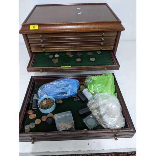 46 - A mahogany six-drawer collector's coin cabinet containing a small quantity of commemorative and fore... 