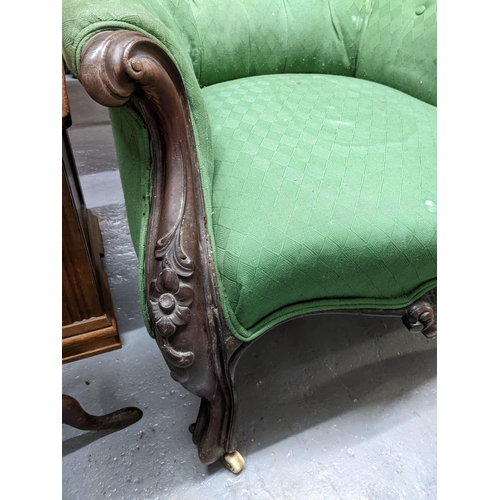 58 - A late Victorian mahogany framed upholstered armchair with carved decoration, on porcelain casters
L... 