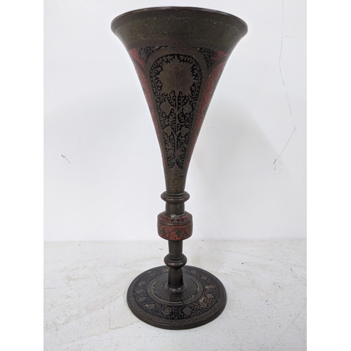 80 - A possibly Iranian late 19th/early 20th century brass trumpet vase decorated with repeating red and ... 