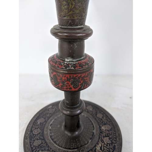 80 - A possibly Iranian late 19th/early 20th century brass trumpet vase decorated with repeating red and ... 