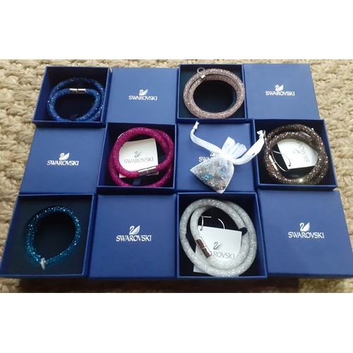 30 - Swarovski-A group of 6 boxed Stardust double bracelets in the following colours pink, copper, silver... 